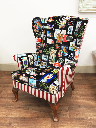 A Parker Knoll upholstered armchair with white and red striping and a patchwork design.