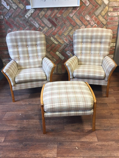 two white and grey tartan armchairs and a footrest.